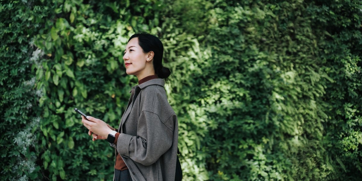 woman standing by green wall